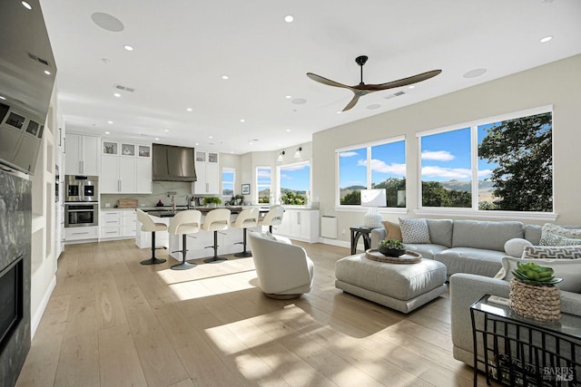 5313 Autumn Rock Ct, Fairfield, CA 94534 - living area featuring ceiling fan, light wood finished floors, recessed lighting, and a fireplace
