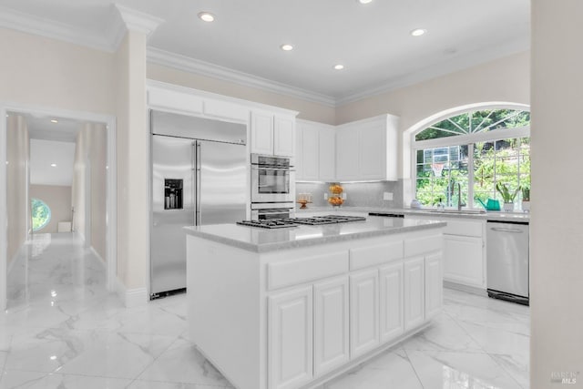 955 Appleridge Pl, Fairfield, CA 94534 - kitchen with appliances with stainless steel finishes, light marble finish floors, a kitchen island, decorative backsplash, and crown molding