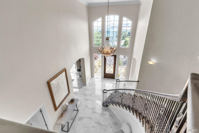 955 Appleridge Pl, Fairfield, CA 94534 - entrance foyer featuring a chandelier, marble look tile flooring, arched walkways, a towering ceiling, and crown molding