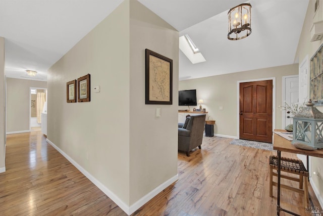2783 Vista Palomar, Fairfield, CA 94534 - foyer entrance with a skylight, light wood-type flooring, vaulted ceiling, and a chandelier