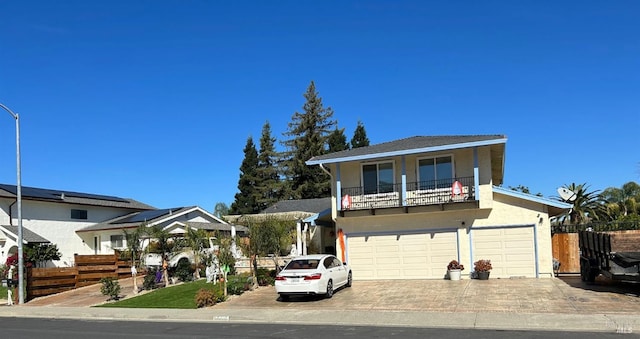 3418 Astoria Ct, Fairfield, CA 94534 - view of front facade featuring a garage, a balcony, stucco siding, and driveway