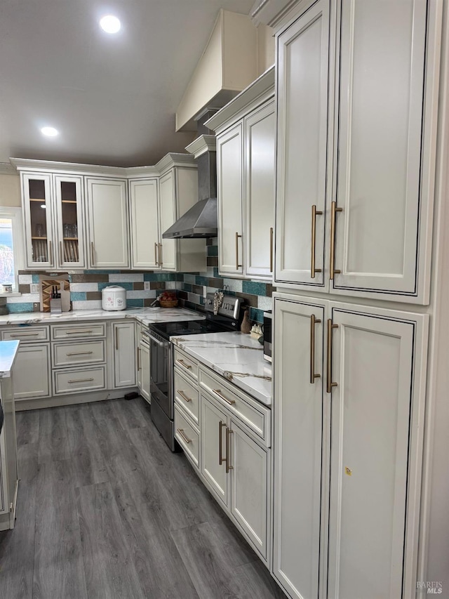 3418 Astoria Ct, Fairfield, CA 94534 - kitchen featuring electric range, dark wood-style floors, glass insert cabinets, wall chimney range hood, and backsplash
