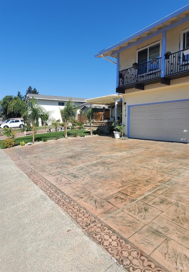 3418 Astoria Ct, Fairfield, CA 94534 - view of front of home featuring stucco siding, driveway, a balcony, and an attached garage