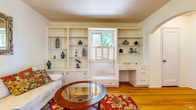 312 12th St, Petaluma, CA 94954 - living area featuring light wood finished floors, plenty of natural light, arched walkways, and built in desk