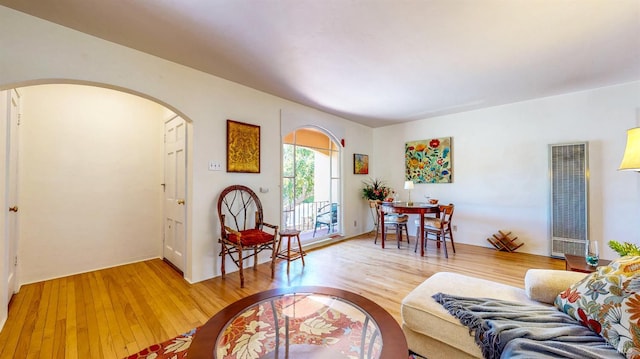 312 12th St, Petaluma, CA 94954 - living room with a heating unit, arched walkways, and light wood finished floors