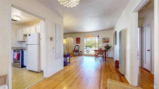 312 12th St, Petaluma, CA 94954 - corridor with arched walkways, a heating unit, and light wood-style floors
