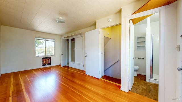 312 12th St, Petaluma, CA 94954 - unfurnished bedroom with heating unit, wood finished floors, ensuite bathroom, and a closet