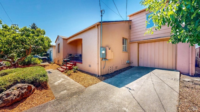 312 12th St, Petaluma, CA 94954 - view of side of home with driveway, a garage, and stucco siding