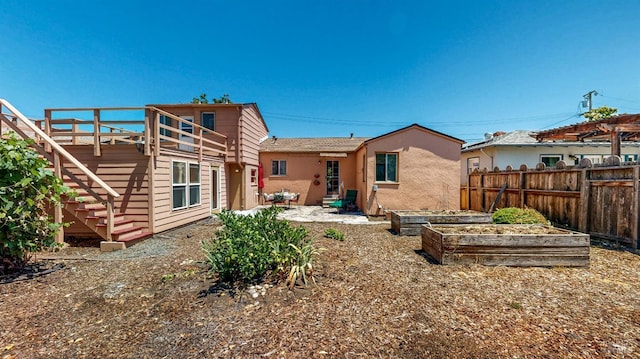 312 12th St, Petaluma, CA 94954 - back of house featuring a vegetable garden, stucco siding, and stairs