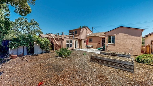 312 12th St, Petaluma, CA 94954 - rear view of house with stucco siding, stairs, a garden, and a wooden deck