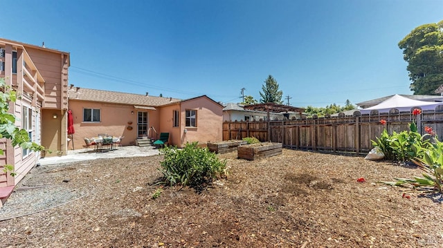 312 12th St, Petaluma, CA 94954 - back of property with entry steps, a fenced backyard, a patio area, and stucco siding