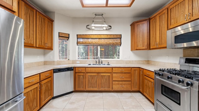 2077 Bourbon St, Pollock Pines, CA 95726 - kitchen featuring appliances with stainless steel finishes, light countertops, brown cabinetry, and light tile patterned flooring