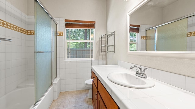 2077 Bourbon St, Pollock Pines, CA 95726 - full bathroom with vanity, healthy amount of natural light, tile patterned floors, shower / bath combination with glass door, and tile walls