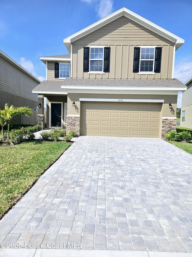 view of front facade with a front lawn and a garage