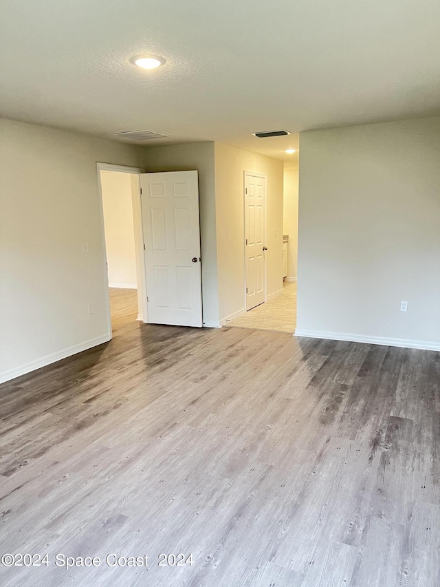 unfurnished room with wood-type flooring