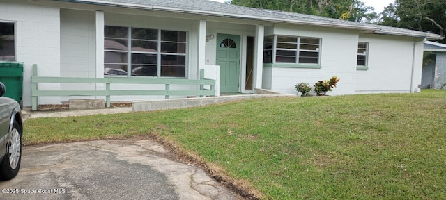 2430 Legay St, Cocoa, FL 32926 - view of front of home with a front lawn and a shingled roof