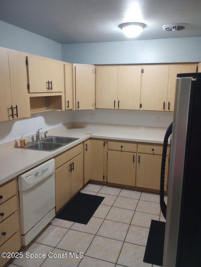 2430 Legay St, Cocoa, FL 32926 - kitchen with dishwasher, freestanding refrigerator, light brown cabinetry, and light countertops