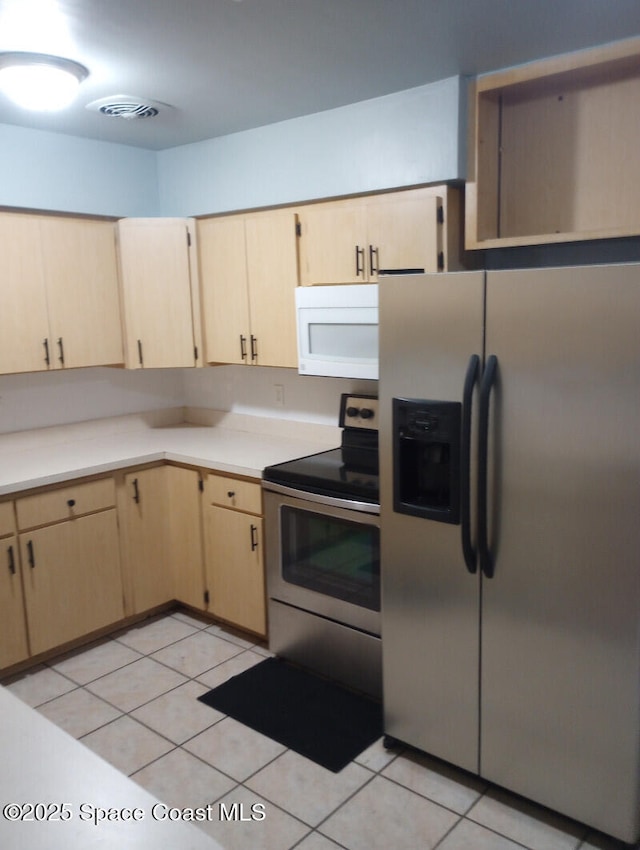 2430 Legay St, Cocoa, FL 32926 - kitchen with stainless steel appliances, light brown cabinets, and light countertops