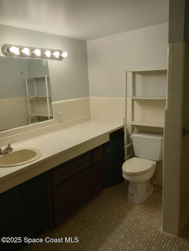 2430 Legay St, Cocoa, FL 32926 - full bath with vanity, wainscoting, tile patterned floors, and tile walls