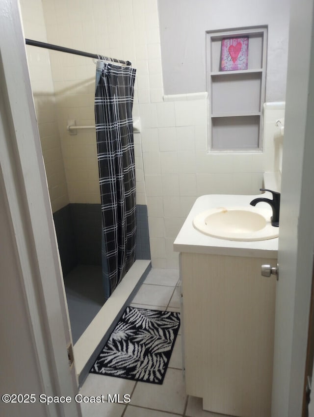 2430 Legay St, Cocoa, FL 32926 - full bathroom with tile walls, vanity, a shower stall, and tile patterned floors