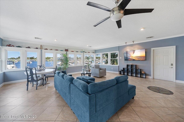 tiled living room featuring a water view, crown molding, ceiling fan, and a wealth of natural light