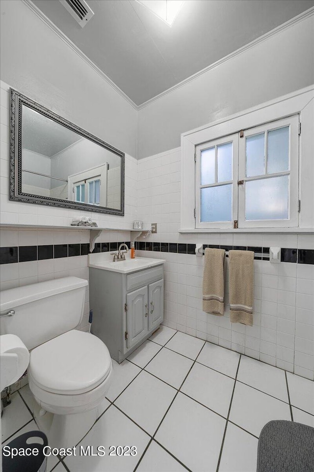 bathroom with tile walls and tile floors