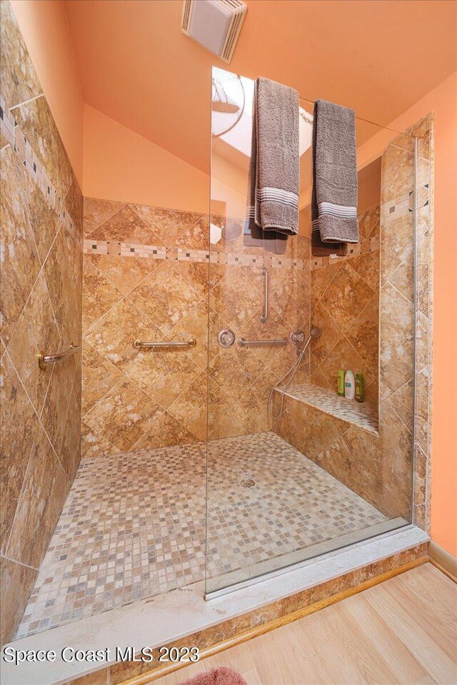 bathroom featuring a shower with shower door