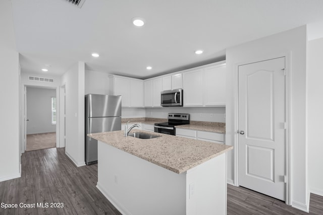 kitchen with white cabinetry, appliances with stainless steel finishes, sink, a kitchen island with sink, and dark hardwood / wood-style flooring