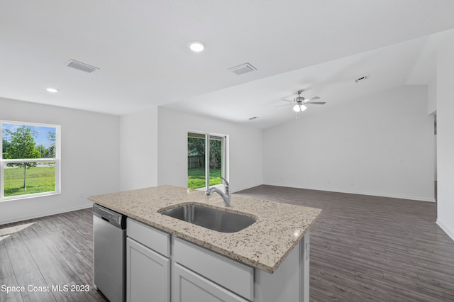 kitchen with dark hardwood / wood-style floors, a kitchen island with sink, dishwasher, and sink