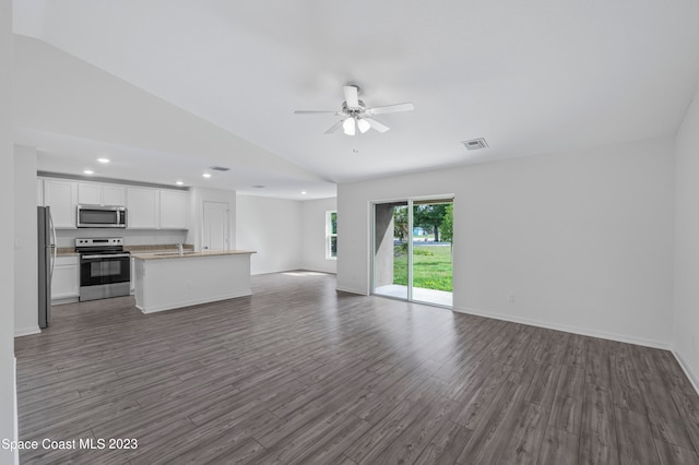 kitchen featuring lofted ceiling, white cabinetry, ceiling fan, dark wood-type flooring, and stainless steel appliances