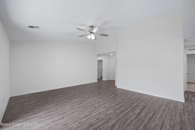 unfurnished room with dark hardwood / wood-style floors, ceiling fan, and lofted ceiling