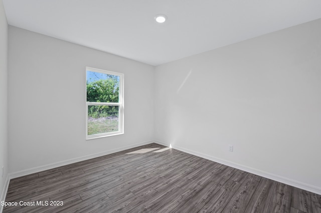 spare room featuring dark wood-type flooring