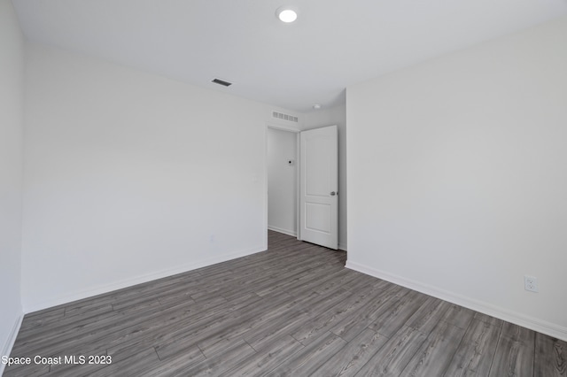 spare room featuring dark wood-type flooring