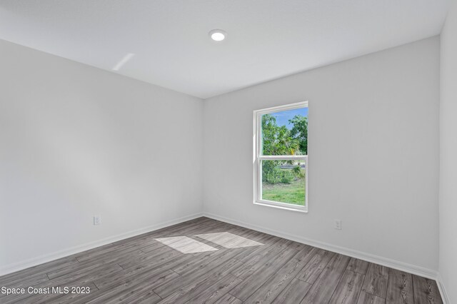 spare room with wood-type flooring