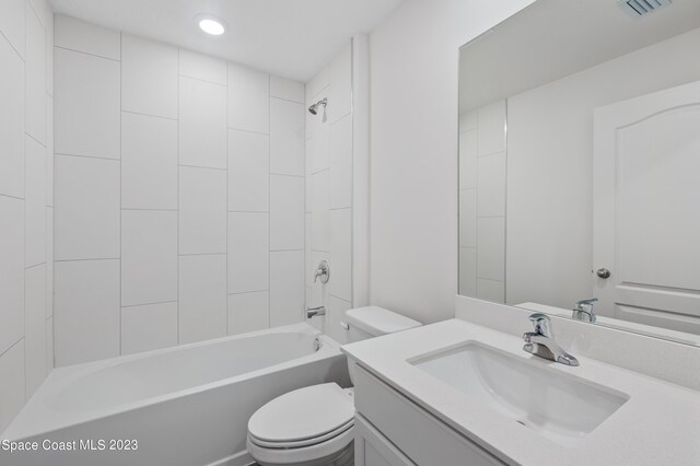 full bathroom featuring large vanity, toilet, and tiled shower / bath