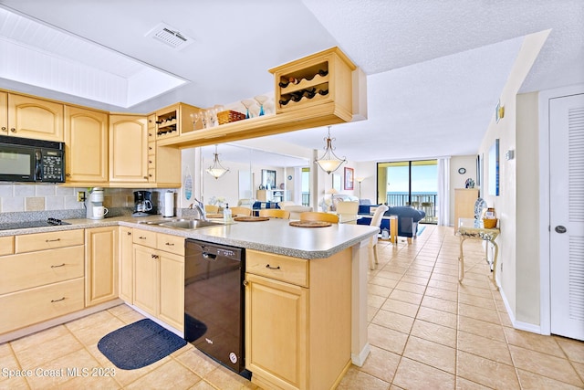 kitchen featuring tasteful backsplash, light brown cabinetry, black appliances, hanging light fixtures, and sink