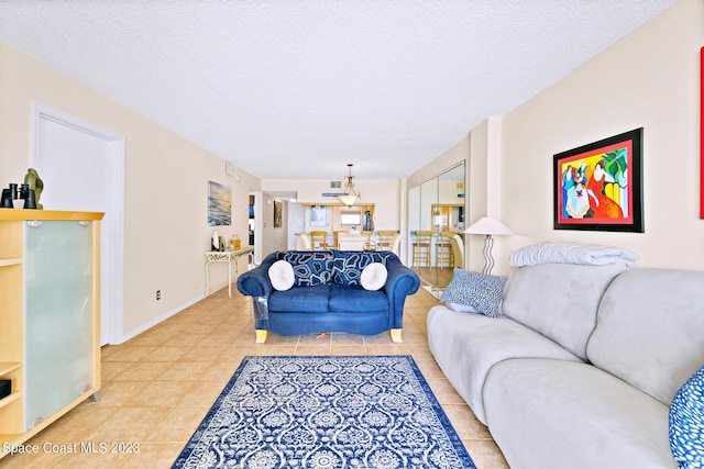 living room with a textured ceiling and light tile floors