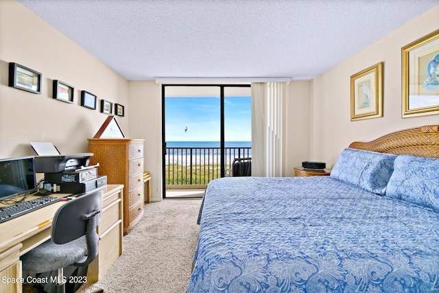 bedroom with light colored carpet, expansive windows, access to exterior, a textured ceiling, and a water view