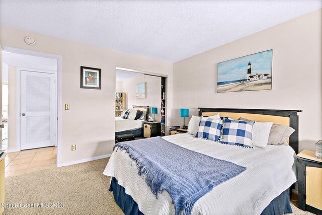 tiled bedroom featuring a textured ceiling and a closet