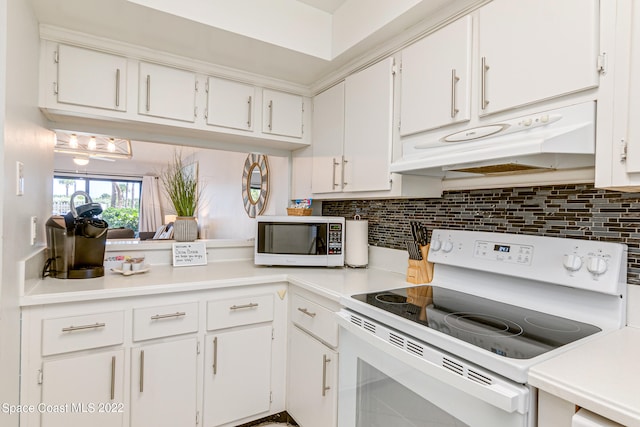 kitchen with backsplash, white appliances, and white cabinetry