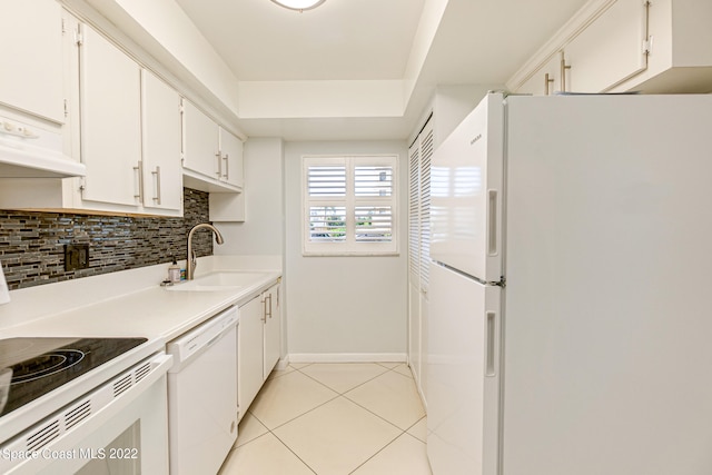 kitchen featuring white appliances, sink, light tile floors, backsplash, and white cabinetry