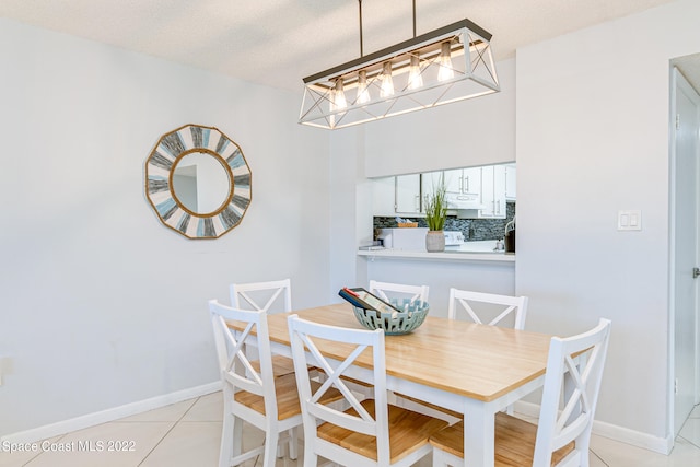 dining room featuring a textured ceiling and light tile floors