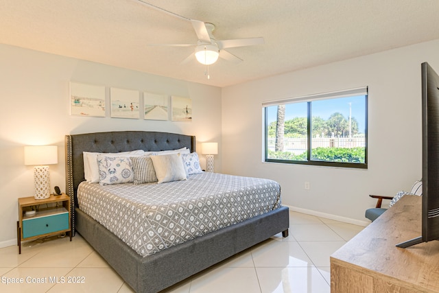 bedroom with ceiling fan and light tile floors