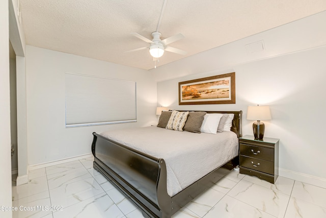 bedroom featuring a textured ceiling, ceiling fan, and light tile flooring