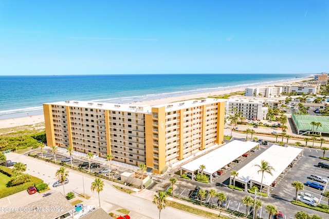 drone / aerial view with a beach view and a water view