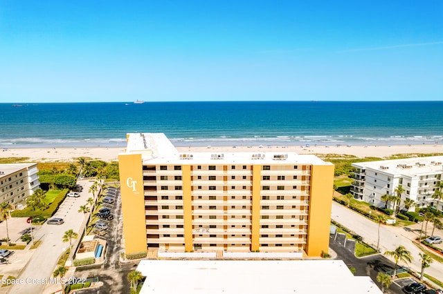 aerial view featuring a view of the beach and a water view