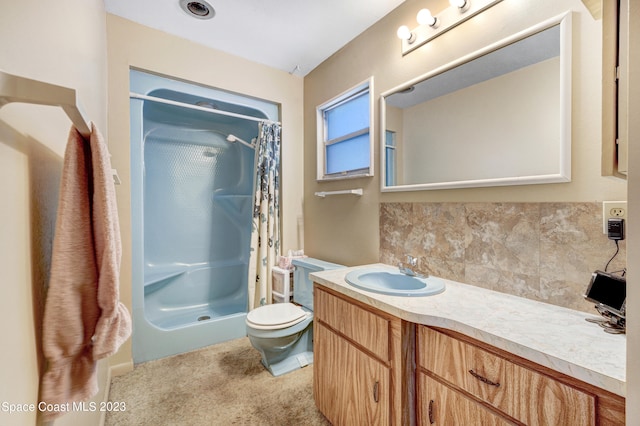 bathroom featuring toilet, vanity, and a shower with shower curtain