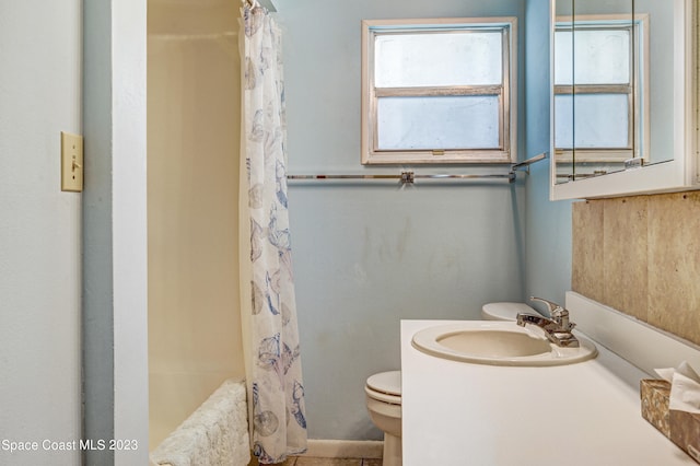 bathroom with vanity with extensive cabinet space and toilet