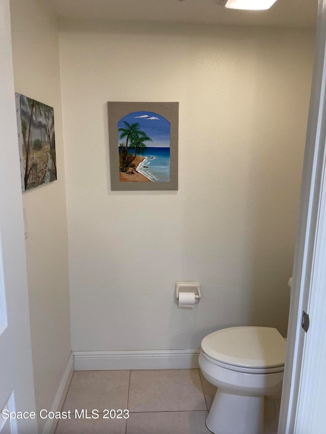 bathroom with toilet and tile flooring