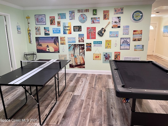 recreation room with pool table, dark hardwood / wood-style floors, and crown molding